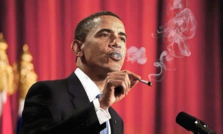 A person speaking at a podium with a microphone, exhaling smoke, set against a red background with flags.